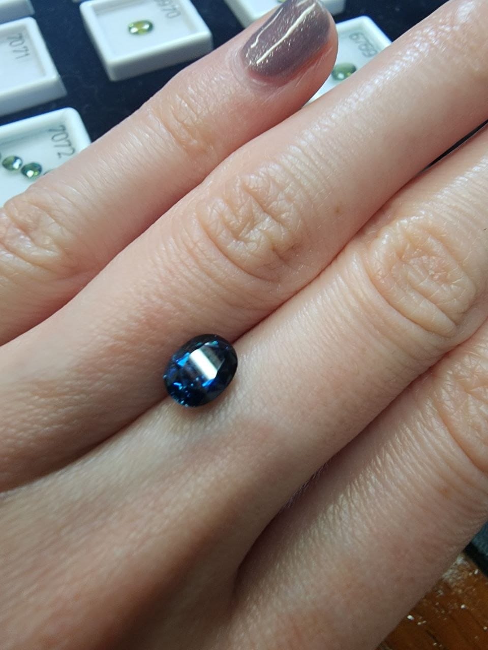 Blue Australian Sapphire 1.47ct Oval — actual stone, photographed on the hand for scale — Ministry of Gems