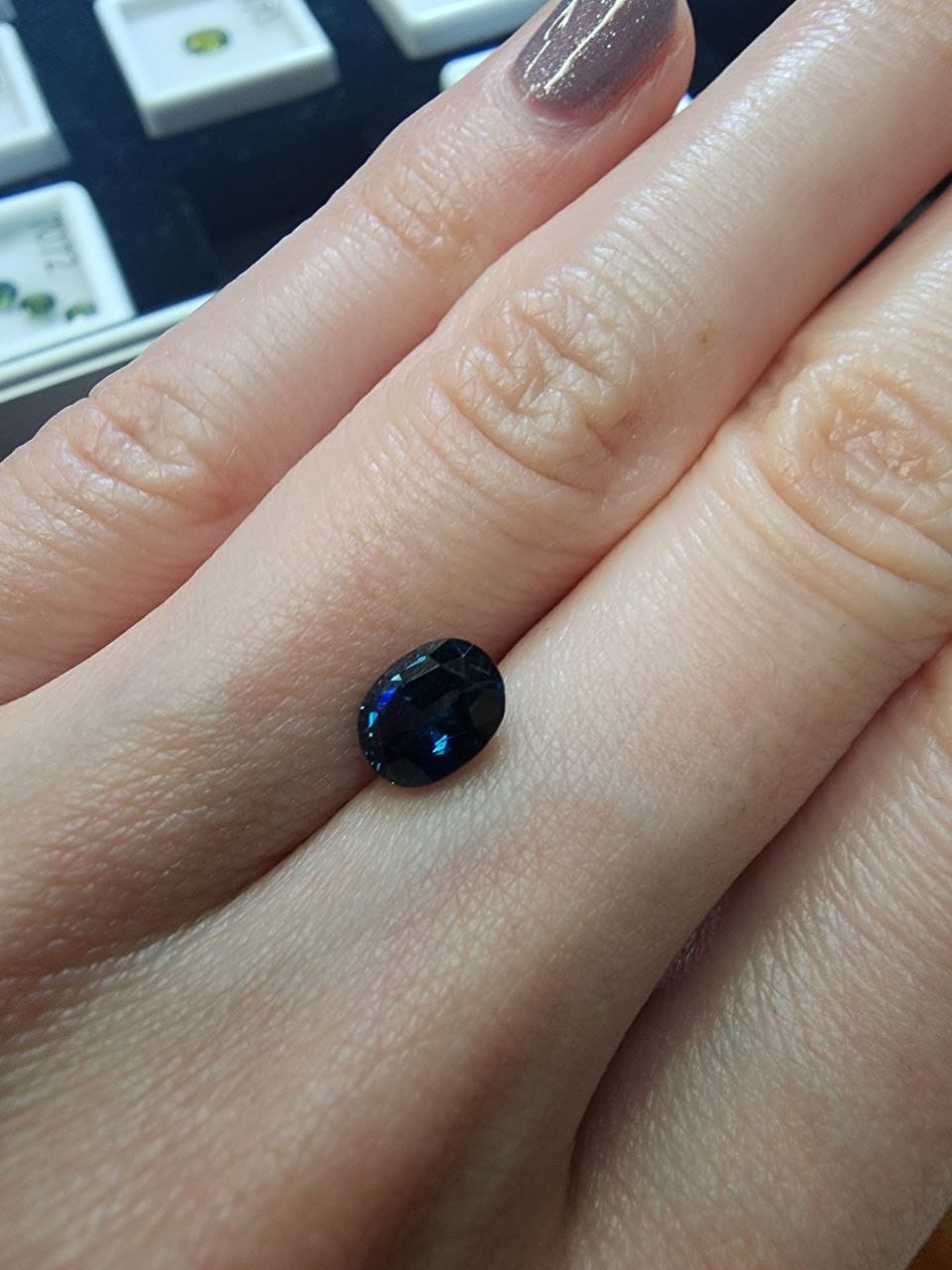 Blue Australian Sapphire 1.47ct Oval — actual stone, photographed on the hand for scale — Ministry of Gems (view 2)