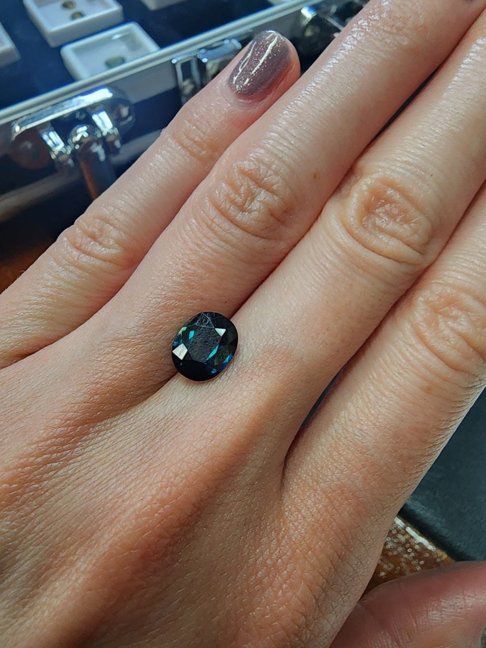 Blue-Green Australian Sapphire 2.21ct Oval — actual stone, photographed on the hand for scale — Ministry of Gems