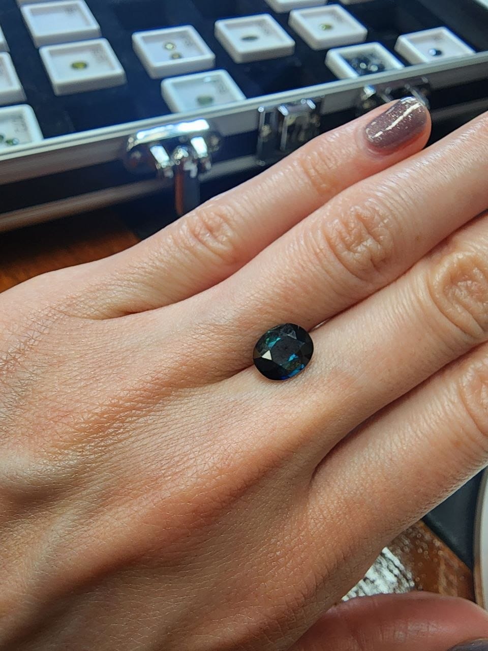 Blue-Green Australian Sapphire 2.21ct Oval — actual stone, photographed on the hand for scale — Ministry of Gems (view 2)