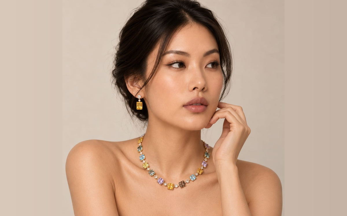 Ministry of Gems model wearing a multicolour sapphire necklace and drop earrings