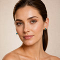 Model wearing the Coiled Fire australian opal earrings in 14K Gold — Ministry of Gems